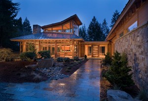 With its glass walls, off-center hip roof, and unique glazed monitor, this houses great room wing cuts a dashing figure. The scenery inside is equally dramatic.