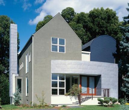 Traditional materials like stucco and clapboard siding blend well with the neighborhood. The asymmetric fenestration adds modern sensibility.