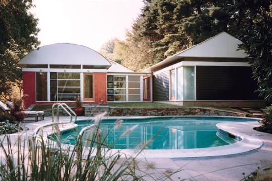 The renovated house is a sequence of pavilions articulated by varied colors, finish materials, and roof lines. Large expanses of glass along the rear elevation help blur the distinction between indoor and outdoor spaces.