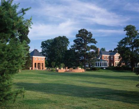 The pool pavilion sits on direct axis with the main house and both buildings overlook Leeds Creek. Old growth trees were preserved and screen views between house and pavilion while a brick pathway with a large dining terrace to one side links the two structures.