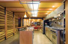 Credit: Lara Swimmer Bell speced energy-efficient fluorescent lights throughout his house, but he wanted a softer glow. So he customdesigned a kitchen fixture that diffuses the light with frostedglass panels held in place by a slim steel grid.