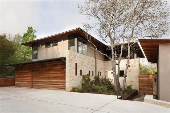 The house is clad in Lueders limestone from west Texas. Garage and fencing are made of durable, sustainably harvested garapa.