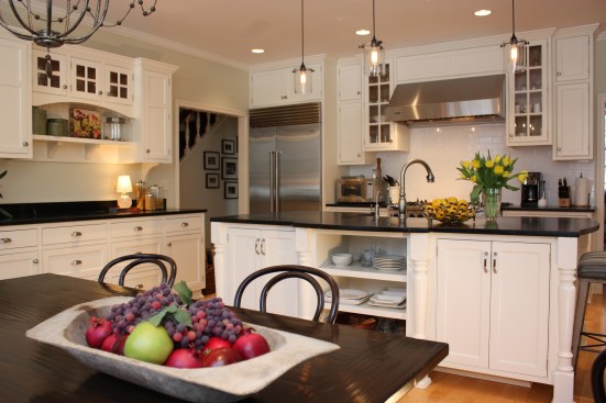 This farmhouse had received several updates and renova-
tions over the years. However, the floor plan was conflict-
ing amongst the kitchen, laundry, mudroom, and powder 
room. A complete reorganization of the first floor was 
achieved through multiple structural changes that al-
lowed for a larger kitchen and created better flow be-
tween adjacent rooms. The kitchen includes custom 
painted cabinetry, a farmhouse style sink, and soapstone 
countertops. A commercial size Viking range, hood, and 
Sub Zero refrigerator bring a theme of stainless steel to 
the kitchen which is accentuated by brushed nickel hard-
ware and island faucet. Specialty lighting, glass door 
cabinets, and a grand, eight foot island are just a few of 
the features that make this kitchen stunning.