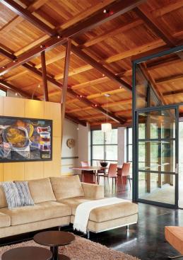 Open to the adjacent dining area, the room is separated from the living area by only a bank of storage cabinets.