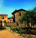 ARTFUL COMPOSITION: An antidote to big-box floor plans, Plan One, which garnered home of the year honors, is a medley of asymmetrical structures. With its clay tile roofing, iron balconies, and curved arcades, the 4,014-square-foot home evokes the region's early Spanish influences.