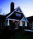 CRAFTY HOMAGE: A Georgia home by Peek Design features the rustic stone, shingling, and 1½-story stature typically found in traditional Craftsman bungalows.