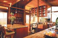 The kitchen is the command center for the house. “From the kitchen you can communicate with people in all of the nearby rooms and see out to all of the exterior spaces,” architect Brad Burke says.