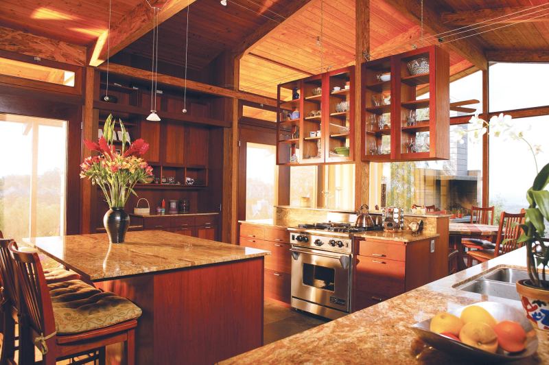 The kitchen is the command center for the house. “From the kitchen you can communicate with people in all of the nearby rooms and see out to all of the exterior spaces,” architect Brad Burke says.