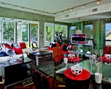 The architect used what was left in terms of the home's allowable height to blow the third level to a 10-foot ceiling, making this space the most loft-like of the three living areas. It also has the advantage of mostly unencumbered natural light, which the design leverages through extensive windows on opposite elevations and an accordion-style patio door out to the balcony.