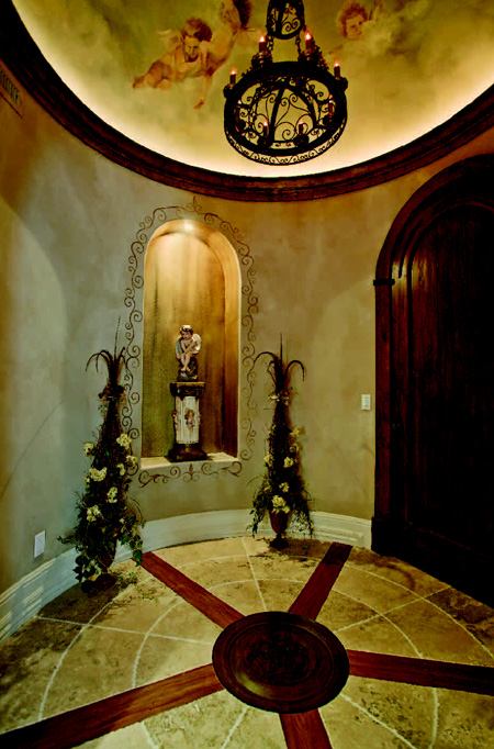 HEAVENLY HALL: A serene vestibule marking the entrance to the master retreat filters the transition from public to private realms.  Ethereal faux paintings, a custom floor medallion, and a lighted art niche invite quiet reflection.