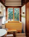 High ceilings and white walls contrast with the warm woods and give a feeling of airiness to the small space.