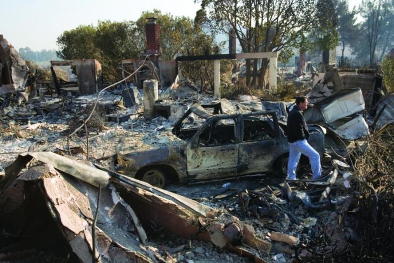 Too hot to handle: Homeowner Jay Gray surveys the destruction to his Rancho Bernardo, Calif., home after fires swept through his neighborhood in October 2007. Few local production builders have had much success participating in the rebuilding efforts.