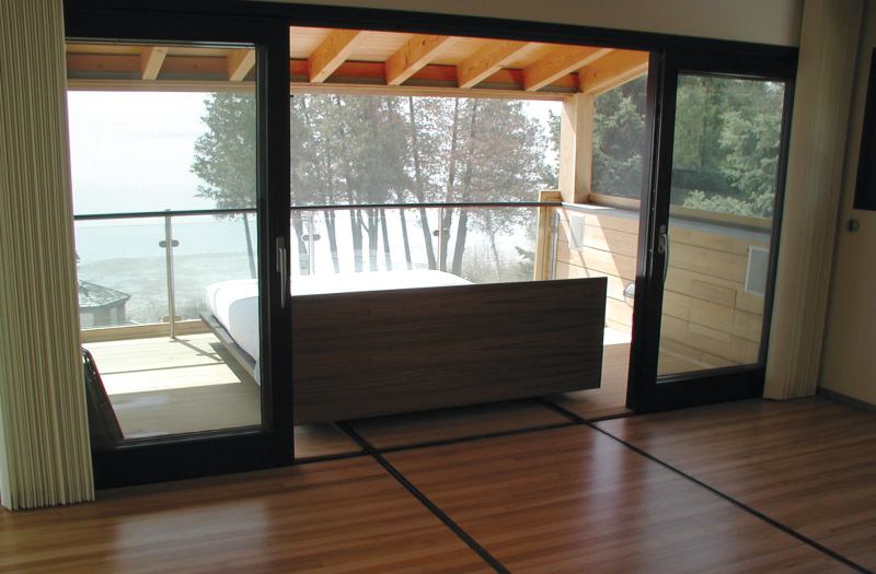 The bed rolls out onto a sheltered, screened porch so the owners can “camp out” even on buggy or stormy nights.