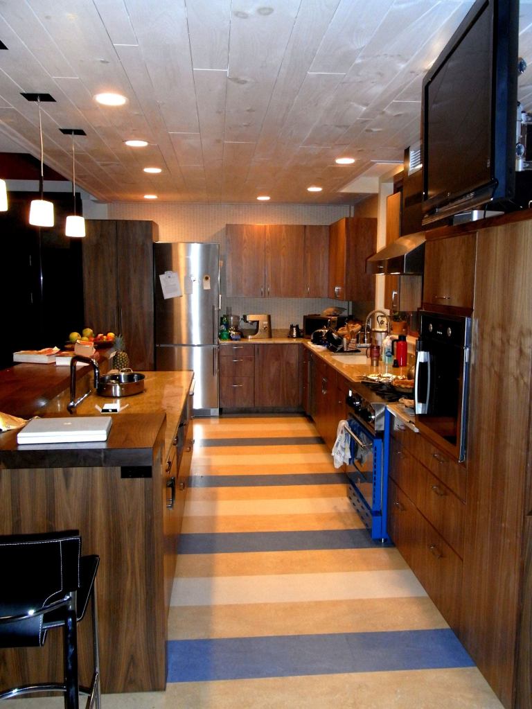 The kitchen ceiling features lumber made from trees taken from the front yard that were milled, kiln-dried in about 60 days, and stained.