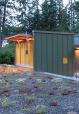 The budget-conscious building is constructed of polycarbonate, wood framing, and metal cladding and is topped with a homemade green roof of drought-tolerant succulents.