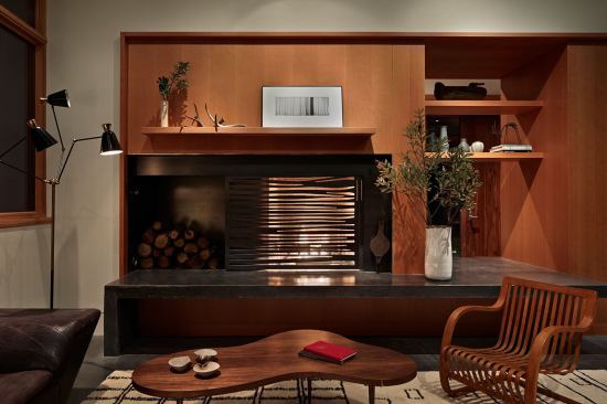 The fireplace’s steel-plate screen echoes the twisting shapes of the exterior sun screen.
