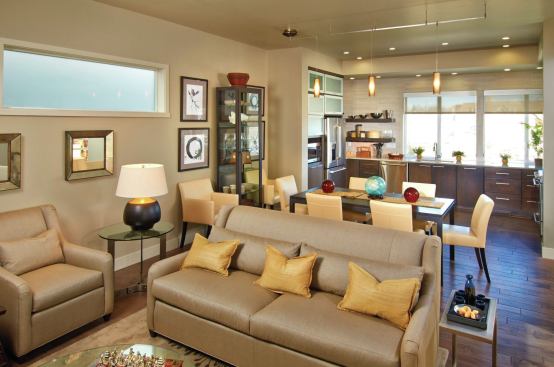 The first floor plan centers on an open great room that places the kitchen at the front of the house, where a wall of windows opens onto the street view.