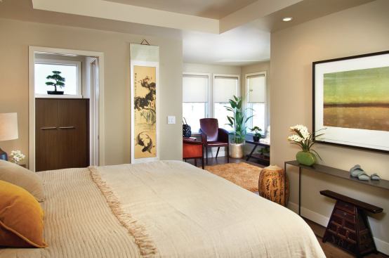 The master bedroom includes a corner seating area with glass on three sides.