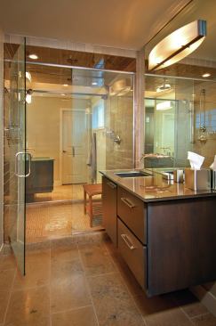 The master bath consists of two separate washing areas that share a glass-walled shower.