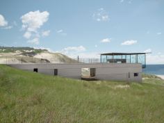 Native dune grasses spread over the roof, helping the building blend with its surroundings.