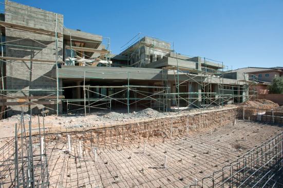 MONEY PIT: Domanico Custom Homes has sunk an unbudgeted $800,000 of its own&nbsp;  money into the project and owes another $400,000 to subcontractors and suppliers. The $1.8 million of financing the company seeks will pay off those debts and finish the house, including an infinity-edged pool&nbsp; that anchors an extensive outdoor living experience.