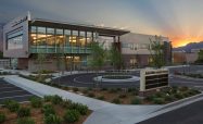 The south-facing exterior at dawn showcases the outdoor healing gardens and large floor-to-ceiling windows, telegraphing mountain views and natural light to the interior.