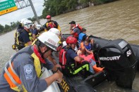 Members of FEMA's Urban Search and Rescue Nebraska Task Force One (NE-TF1) rescue a family&nbsp;from a neighborhood impacted by&nbsp;flooding from Hurricane Harvey