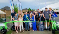 Tim Johnson and Susan Brown, second from left, with residential developer Land Tejas and partners cut the ribbon to officially open the 12-foot GreenBoLT trail system in Balmoral as dozens of Realtors and well-wishers cheer on.