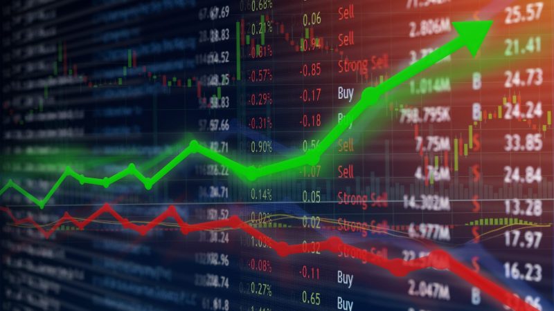 Investing and stock market concept gain and profits with faded candlestick charts.