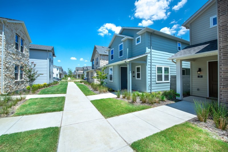 The pedestrian and pet-friendly community includes walkways to each front door with private yards on the side.