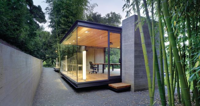 The board-formed concrete towers provide a textured contrast to the smooth glass and steel.
