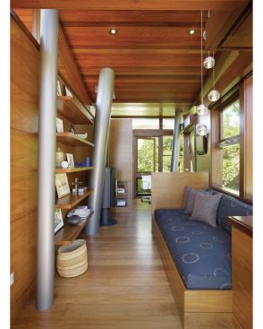 Cedar siding and mahogany floors recall a tree house kind of style, but in a more finished form. Hollow, canted columns serve as support beams for the structure. They’re also the pipes that supply the tree house with running water.