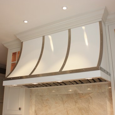 After shaking up the plan by moving walls, eliminating doors and enlarging the window, the new space was furnished with finely tailored cabinetry, quartzite tops and a custom built range hood as the focal point.
