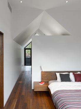 The master suite occupies the entire third floor, opening onto roof decks at the front and rear of the house.