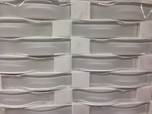 Daltile  Glass mosaics in textured and mixed-material blends are all the rage for Daltile accent and wall tile collections. This Fanfare Intertwine uses slivers of arched glass in six different color blends to add texture to kitchen backsplashes or bathroom trim. 
www.daltile.com