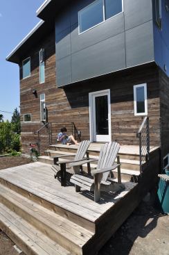The master bedroom cantilevers out above the front porch, shading the main entry.