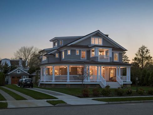 "In this particular beach town and neighborhood, porches are a huge design element,” says Bubnowski.&nbsp;Entrance steps are 12 feet wide, and it's the favorite spot for portraits taken during family gatherings. The original porch was 13 feet deep, and the scale has been maintained.