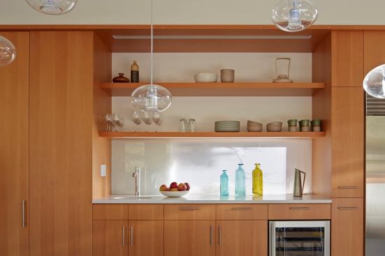 Architect Neal Schwartz admits that he sometimes has trouble convincing clients to go for the less-than conventional move of setting of the fridge around the corner. Adequate landing space right next to the refrigerator helps it all make sense.