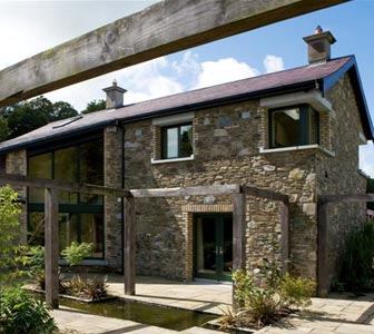 Once a school and private chapel, this 200-year-old estate now serves as a historic residence, thanks to a renovation and addition carefully crafted to match the original stone-faced structures. Plenty of windows frame views of surrounding gardens, cornfields, and beech woods. Project: Tynte Park Lodge, County Wicklow, Ireland; Architect: The Priory, Dublin, Ireland