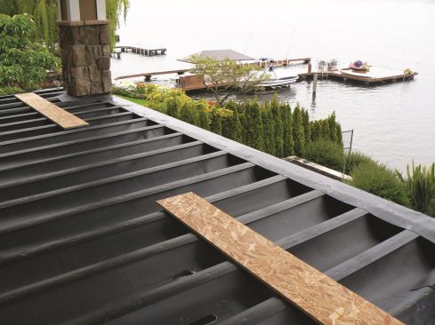 Dek Drain Topside&nbsp; Designed for new construction, Dek Drain Topside attaches to the top of joists before the deck boards are fastened down. The system’s flashing, panels, and cap strips tuck into the bays of the deck, creating a concealed drainage system that keeps the deck frame dry, says the company. Any ceiling materials, finishes, or fixtures can be safely installed beneath the Topside system.&nbsp;
