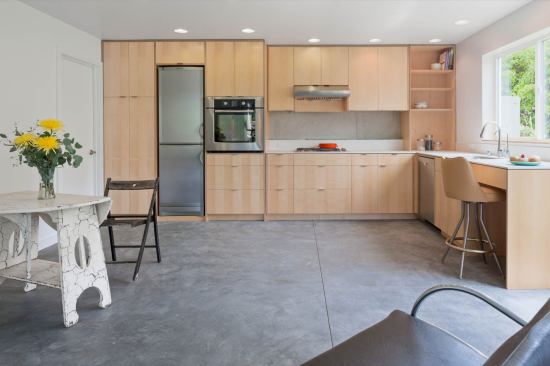 The one-bedroom, 795 square-foot accessory dwelling unit (ADU) at the lower grade has open living with direct connection to a patio and the yard.