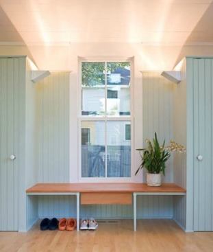 A pair of clutter-concealing closets bookend this custom bench made of vertical-grain fir stair treads that sit atop painted wood legs, creating a functional entryway that feels sublime. Project: Overall House, Concord, Mass.; Architect: Estes/Twombly Architects, Newport, Rhode Island; Builder: Richard Warren, Hand’s On Construction, Concord, Mass.