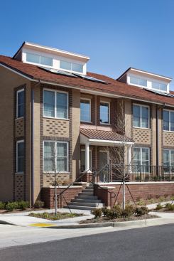 The building is clad in dark red, light red and dark brown brick to create an exterior that gives character to and energizes the fa&ccedil;ade.