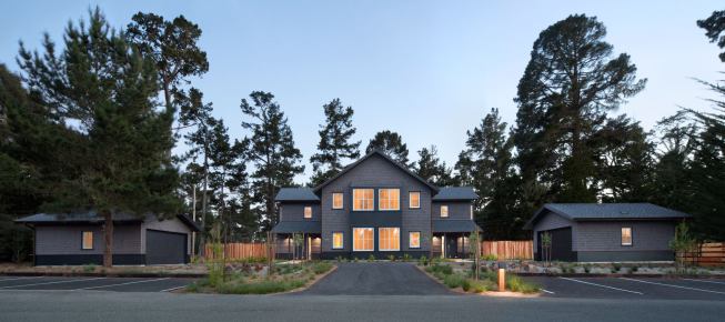 The widest part of the house flanked by twin garages presents a stately facade to the rest of the campus while blending with the scale of the school buildings as well as the dark hues of the wooded site.