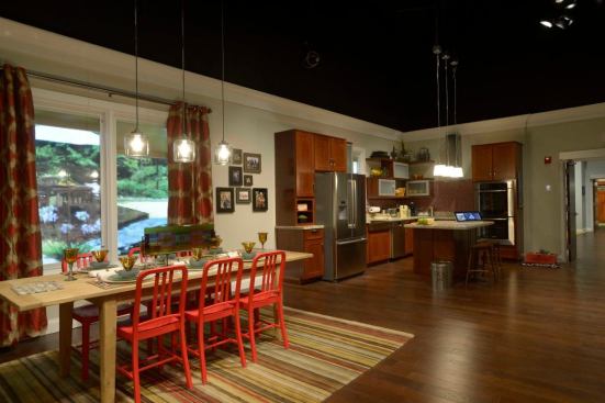Chairs made from recycled plastic and Armstrong walnut flooring created from sustainable sources are featured in the home's great room area. The countertops are made from recycled glass.
