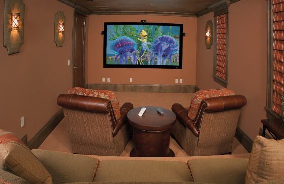 PACK POPCORN: A foot-high platform built along the the back third of the home theatre enables stadium-style seating, with all the works tucked away but accessible in the room's walk-in closet. But the real story is behind the drywall and subfloor, where sound=abatement products help contain studio-quality audio without a peep from the outside world.