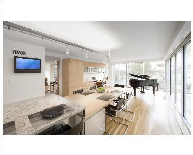This area was originally the family room. The wall separating it from the kitchen was removed, transforming it into a casual dining space with room for a small office as well as a grand piano.