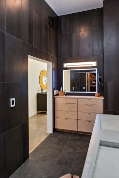 As throughout the house, a sliding "barn door" conserves space. Here, the open door reveals the master bath.