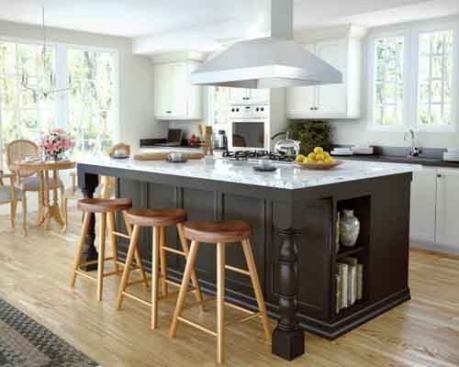 Classic Aesthetic  Black and white makes for a classic kitchen combination. This design features warm cr&egrave;me paint with chocolate antiquing, paired with a burnished Ebony stain to soften the look. The Brentwood recessed-panel door style features mortise-and-tenon construction, and is available in seven wood species, plus three additional species for the Brentwood Solid style with a heavier door. 
Canyon Creek Cabinetry | 800.228.1830 | canyoncreek.com