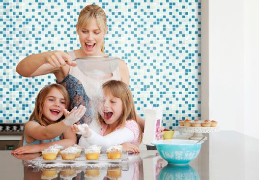 Two girls and a mum baking --- Image by &copy; Fiona Jackson-Downes and Dirk Lindner/cultura/Corbis